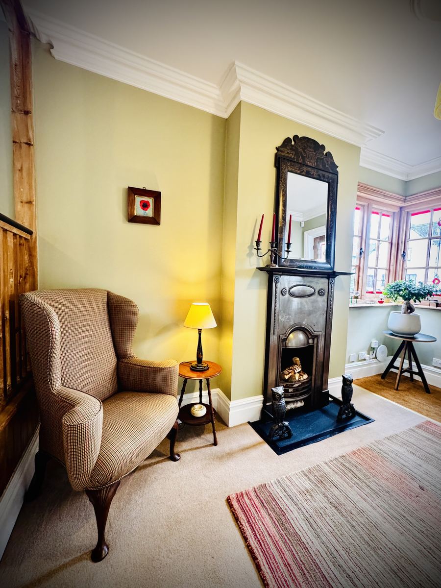 Warm consultation room with armchair and fireplace at Newbridge Care